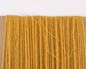 stitching the yarn loops for hair
