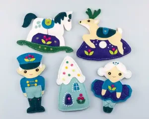 Rocking horse, reindeer, gingerbread house, toy soldier and ballerina doll felt ornaments from the Winter Tales chapter of the book Felt Ornaments for All Occasions