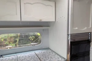 Caravan kitchen area before refurb