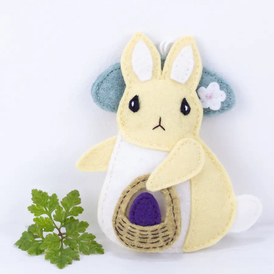 Felt bunny ornament with a flower-trimmed hat and a basket with an Easter egg.