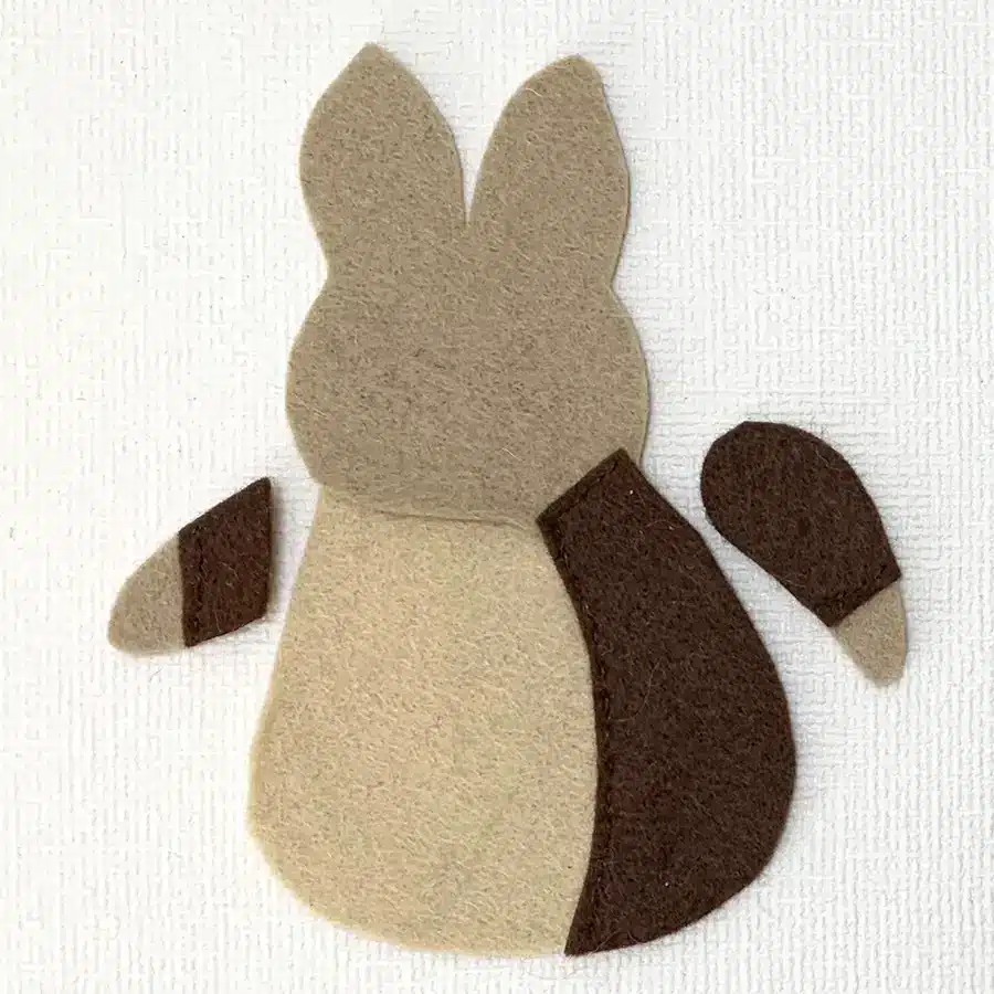 Showing how the body and arms have been cut from brown felt to create the jacket