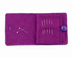 Inside the purple version of the needle book, showing needles and pins stored in the pages