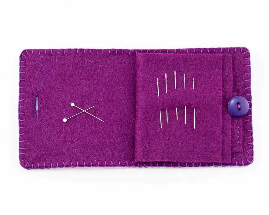 Inside the purple version of the needle book, showing needles and pins stored in the pages