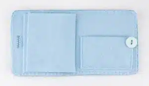 The inside of the needle book showing pages for needles and a small pocket at the back