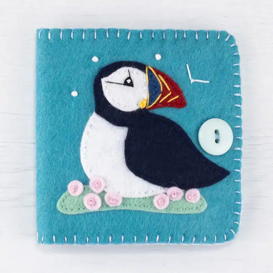 Teal blue felt needle book with puffin applique on the cover