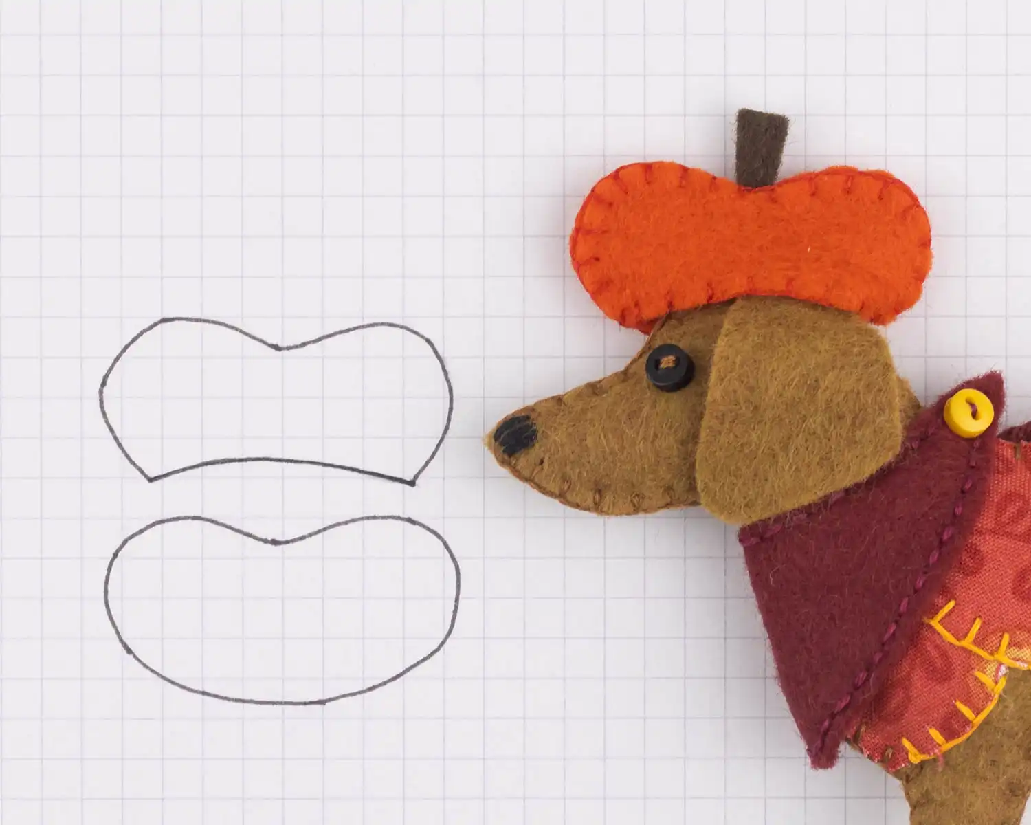 A drawing of the front and back hat shapes, with a close up of a felt dachshund wearing an orange pumpkin shaped hat
