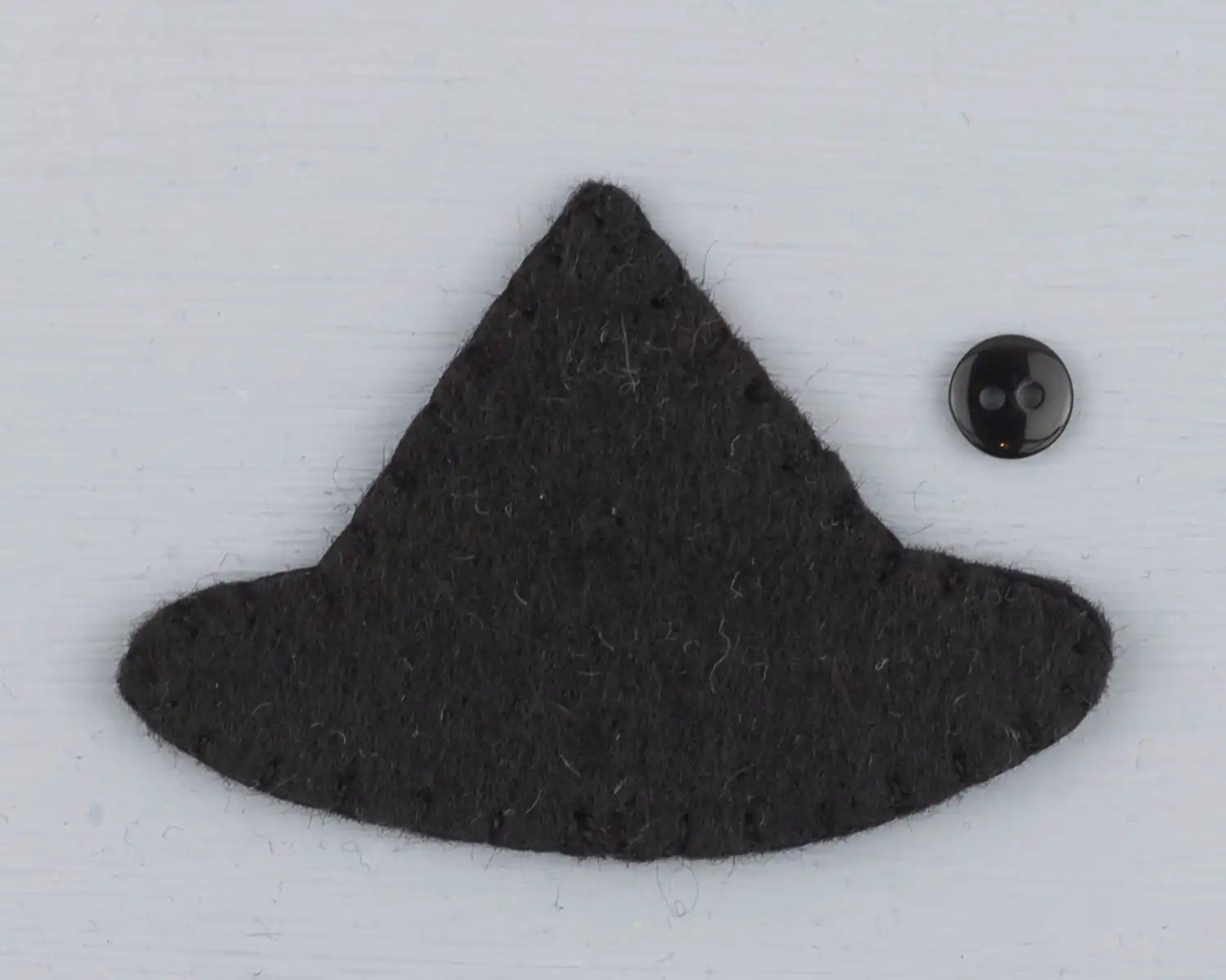 The owl's black hat sewn together