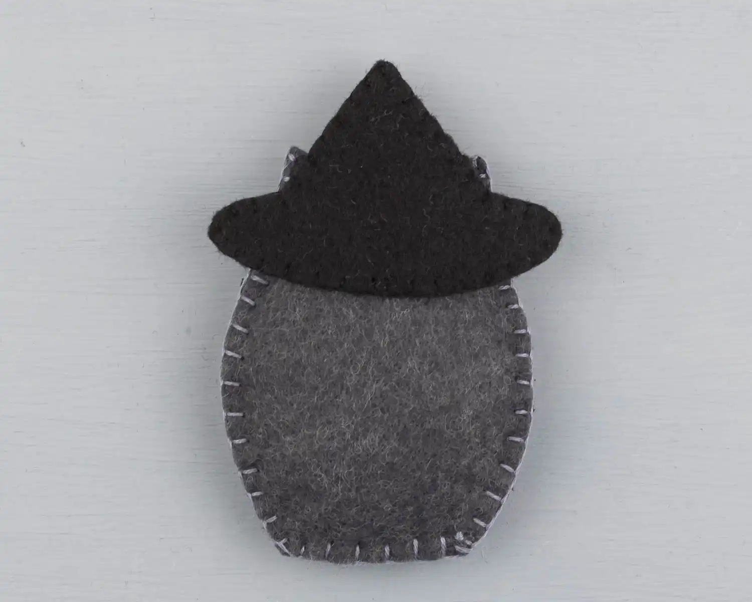 Back view of the owl showing the base of the hat stitched to the owl
